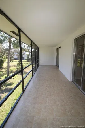 wooden floor in an empty room with a large window