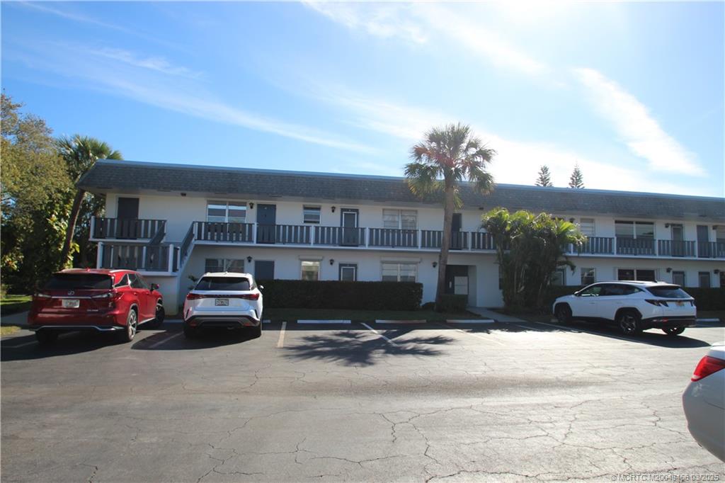 2929 Southeast Ocean Boulevard, Unit 13110 Stuart, FL 34996 - Photo 2 of 25 a view of street with parked cars