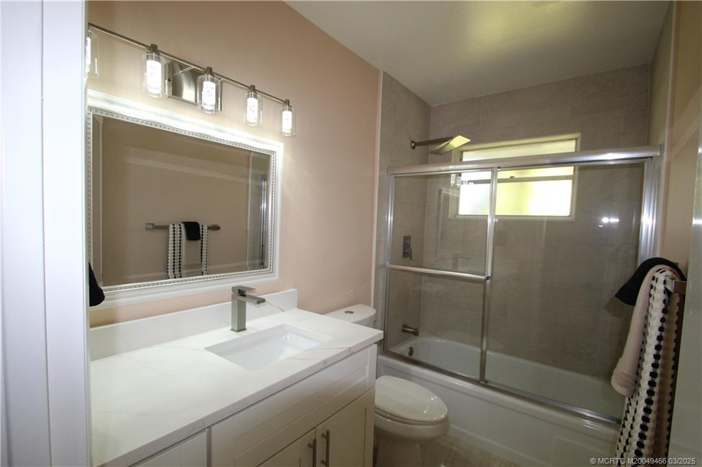 2929 Southeast Ocean Boulevard, Unit 13110 Stuart, FL 34996 - Photo 6 of 25 a bathroom with a sink a toilet and shower