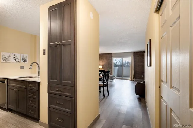 a view of a hallway and a livingroom with furniture