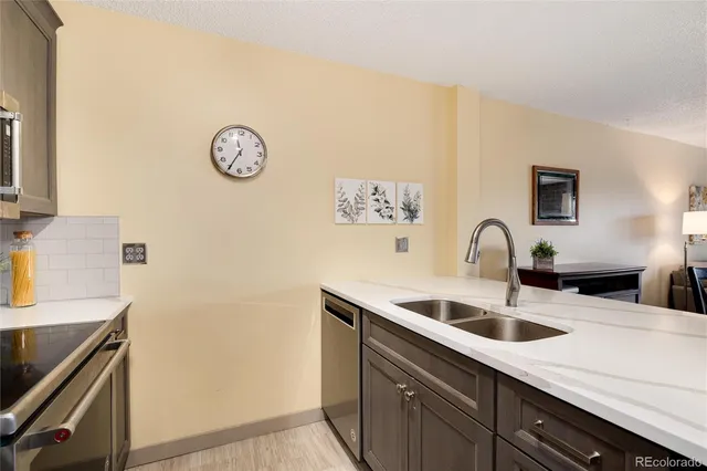 a kitchen with a sink and a refrigerator