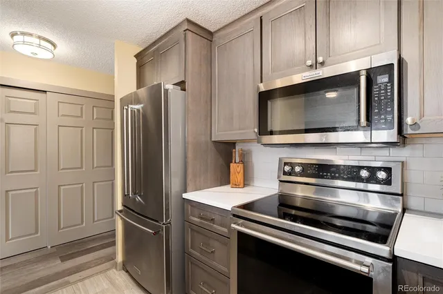 a kitchen with stainless steel appliances and cabinets
