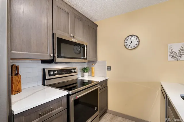 a kitchen with stainless steel appliances a stove a microwave and cabinets