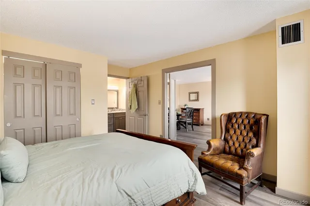 a bedroom with a bed and a chair