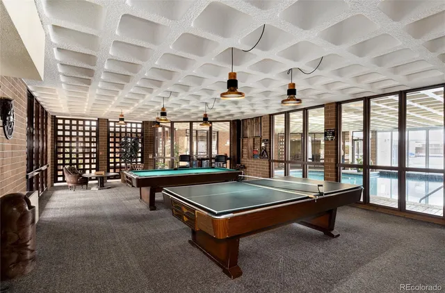 a pool table with chairs