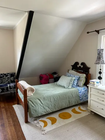 a bedroom with a bed and a car in it