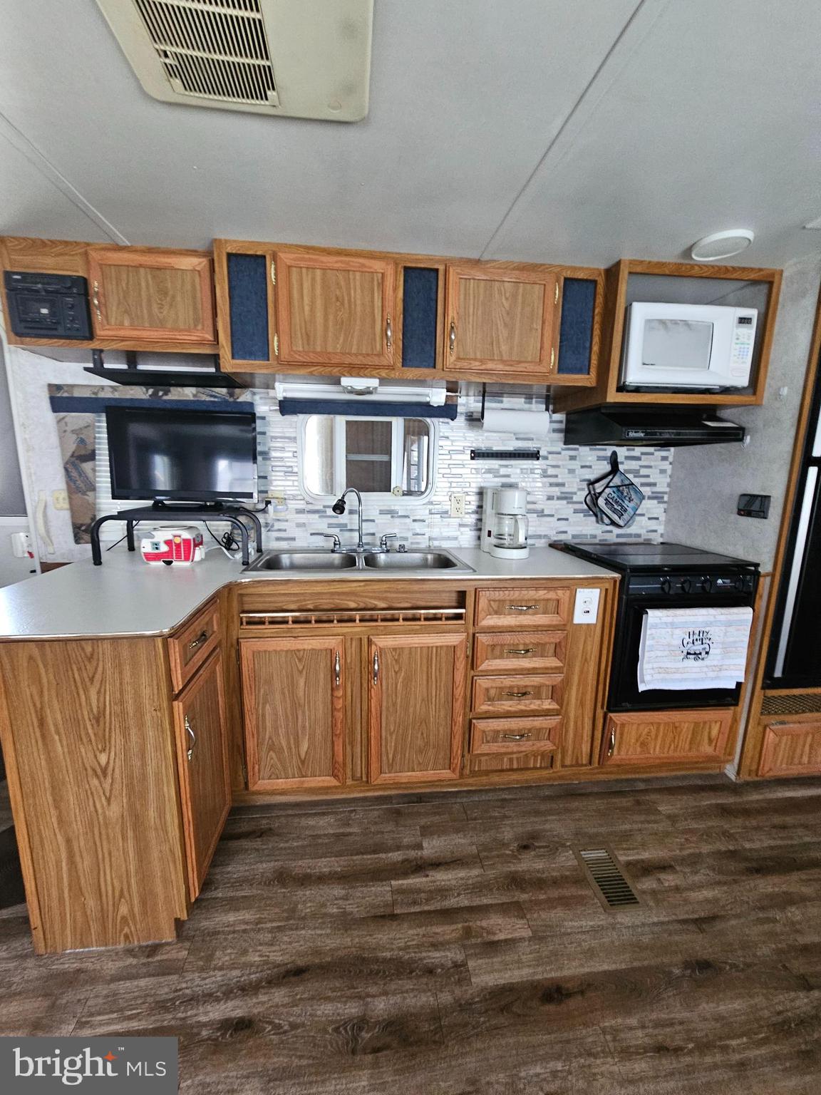 6 Boo Boo Boulevard Falling Waters, WV 25419 - Photo 5 of 19 a kitchen with stainless steel appliances granite countertop a stove a sink dishwasher and a microwave oven with large wooden cabinets