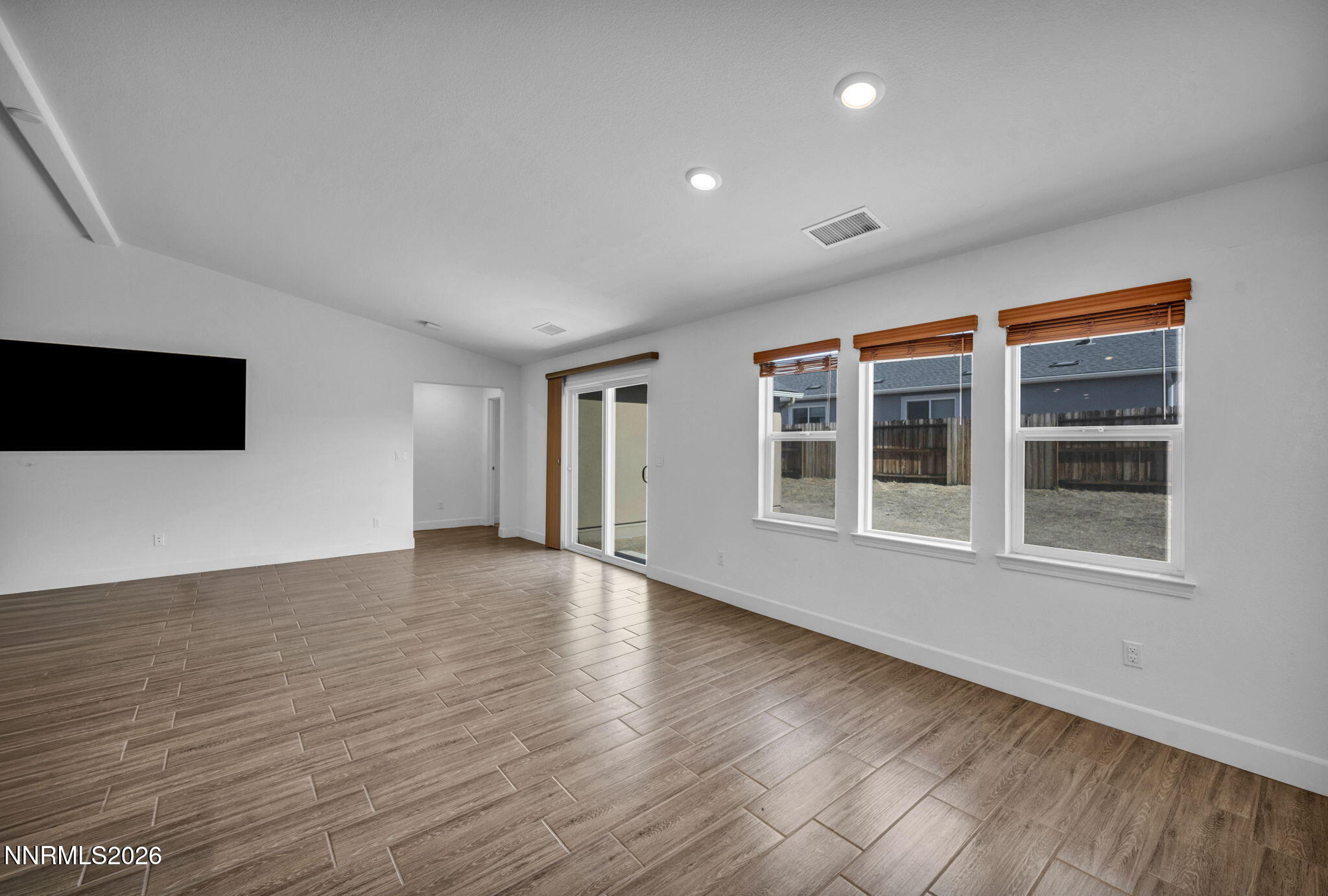 7181 Saddlehorn Road Carson City, NV 89701 - Photo 9 of 62 a view of an empty room with wooden floor and a window