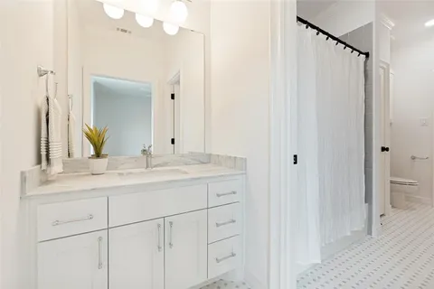 a bathroom with a double vanity sink and mirror