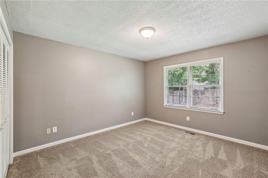 4645 Shallowford Road Roswell, GA 30075 - Photo 21 of 34 an empty room with windows