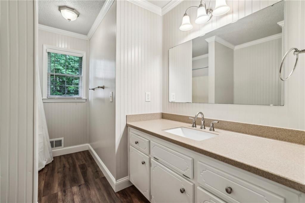 4645 Shallowford Road Roswell, GA 30075 - Photo 22 of 34 a bathroom with a sink a mirror and vanity