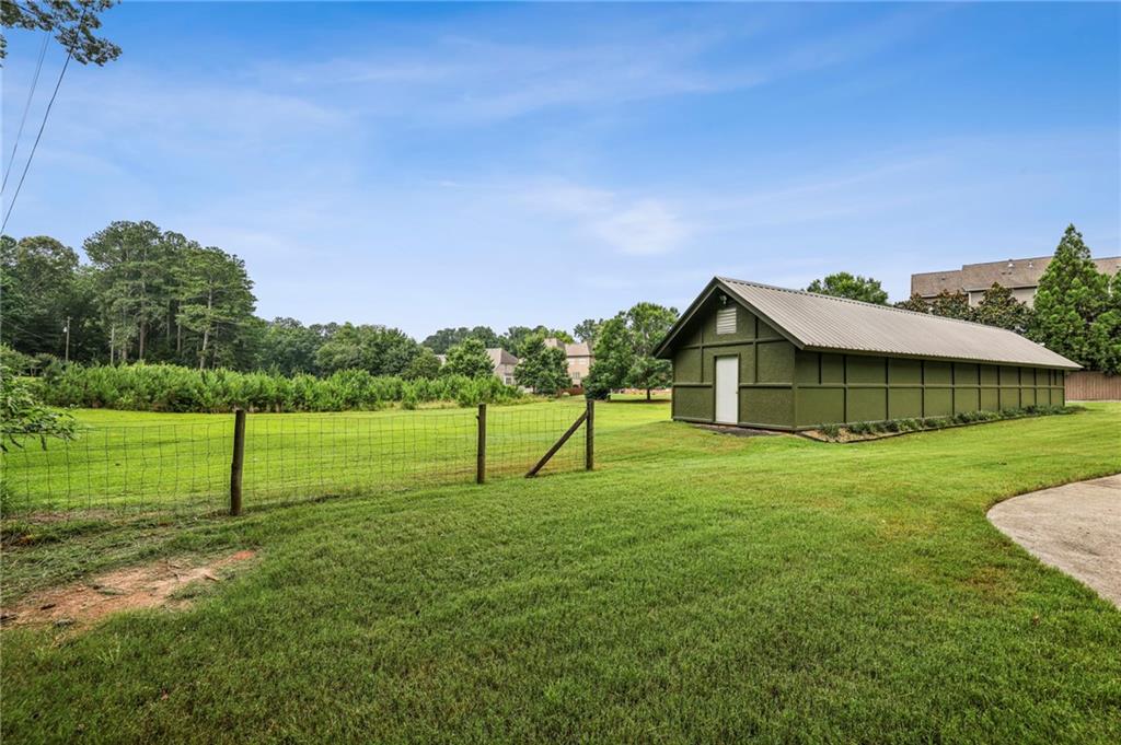 4645 Shallowford Road Roswell, GA 30075 - Photo 25 of 34 a view of a house with a yard and sitting area