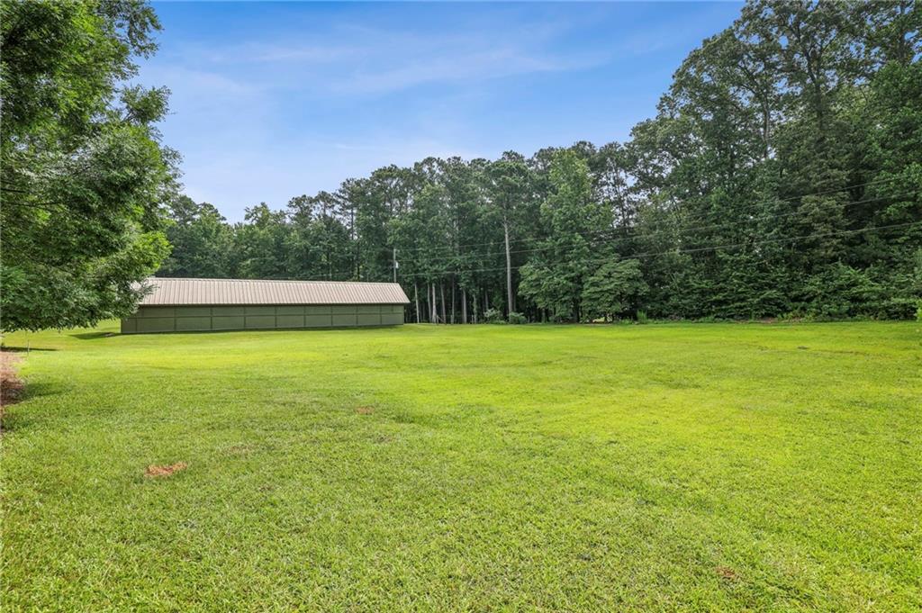 4645 Shallowford Road Roswell, GA 30075 - Photo 27 of 34 a view of a swimming pool with an outdoor space and seating area