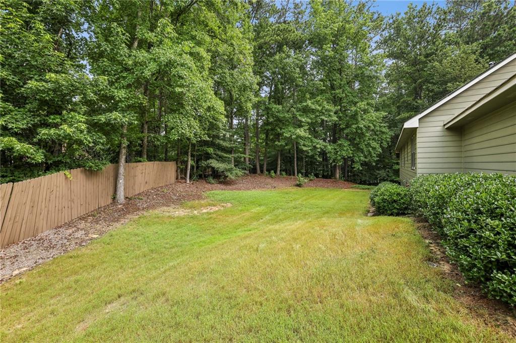 4645 Shallowford Road Roswell, GA 30075 - Photo 29 of 34 a view of a backyard with a small cabin