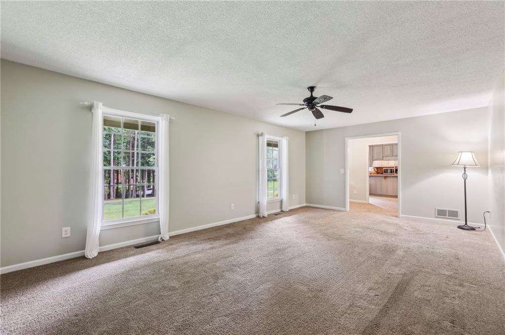 4645 Shallowford Road Roswell, GA 30075 - Photo 7 of 34 a view of a room with a ceiling fan and window