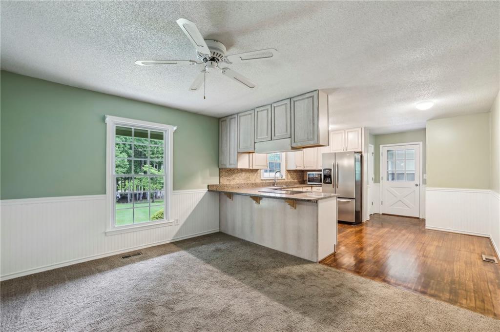 4645 Shallowford Road Roswell, GA 30075 - Photo 9 of 34 a kitchen with a refrigerator and a sink