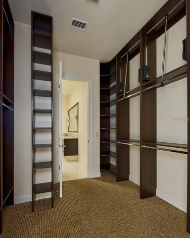 a bedroom with a bed and a potted plant