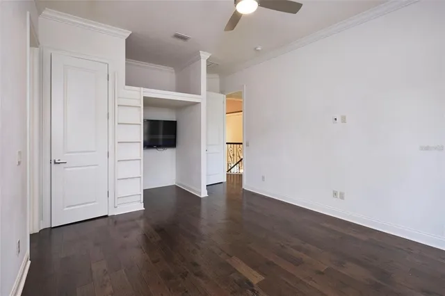 a bedroom with a bed and a potted plant