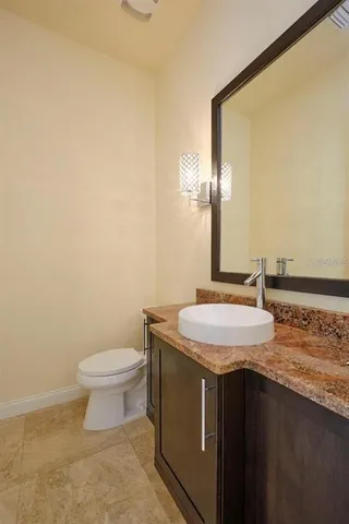 a view of a white house with a big yard and large trees