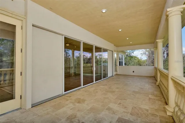 a front view of a house with garden and trees