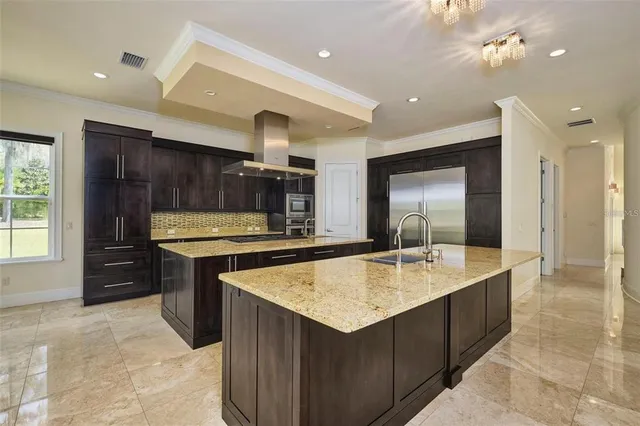 a large kitchen with kitchen island a sink stainless steel appliances and cabinets
