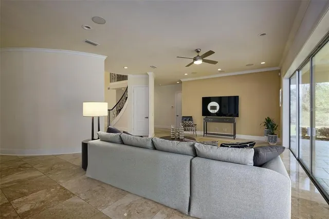 a living room with furniture and a floor to ceiling window