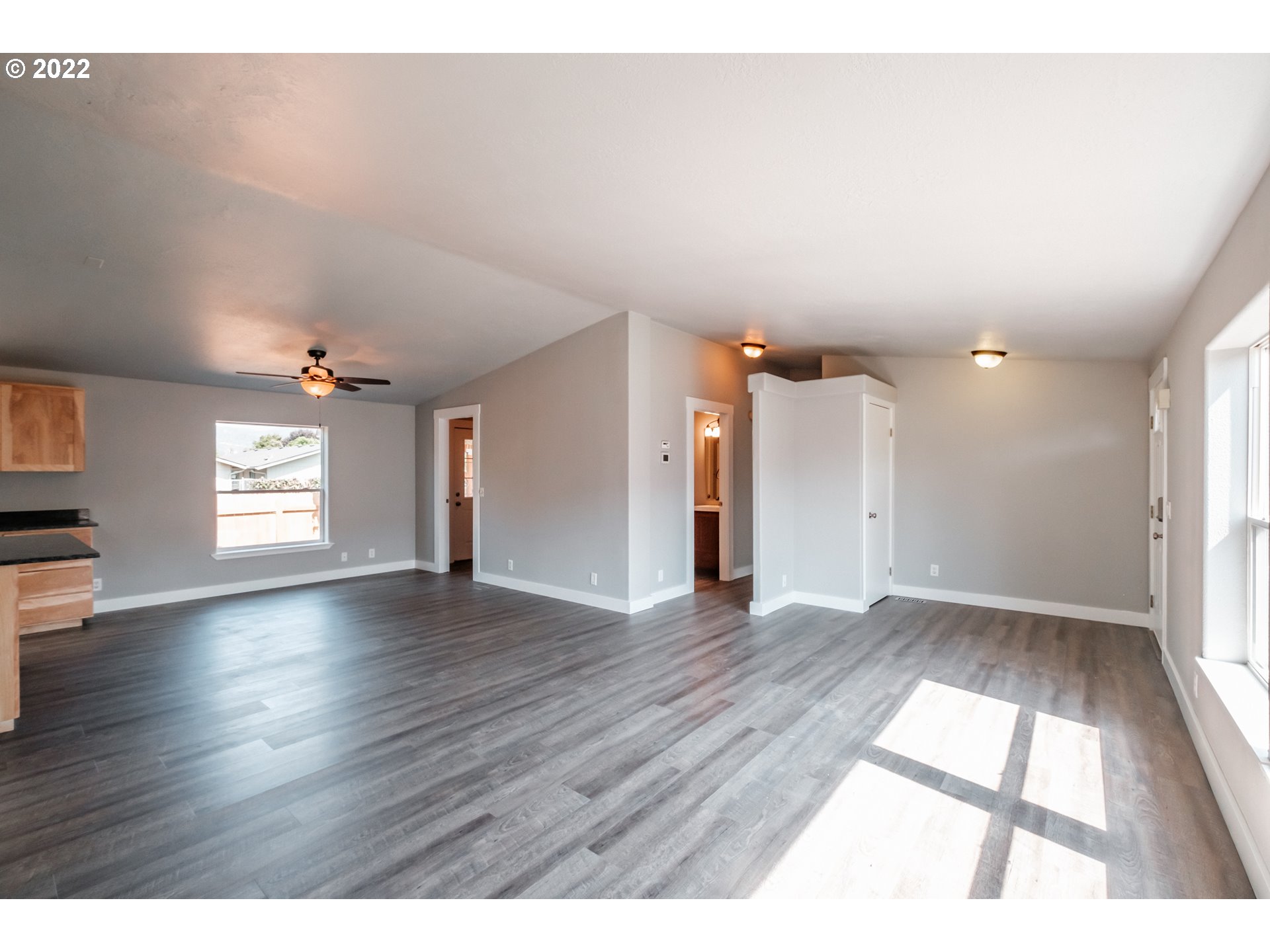 833 Northridge Avenue Springfield, OR 97477 - Photo 6 of 31 an empty room with wooden floor and windows