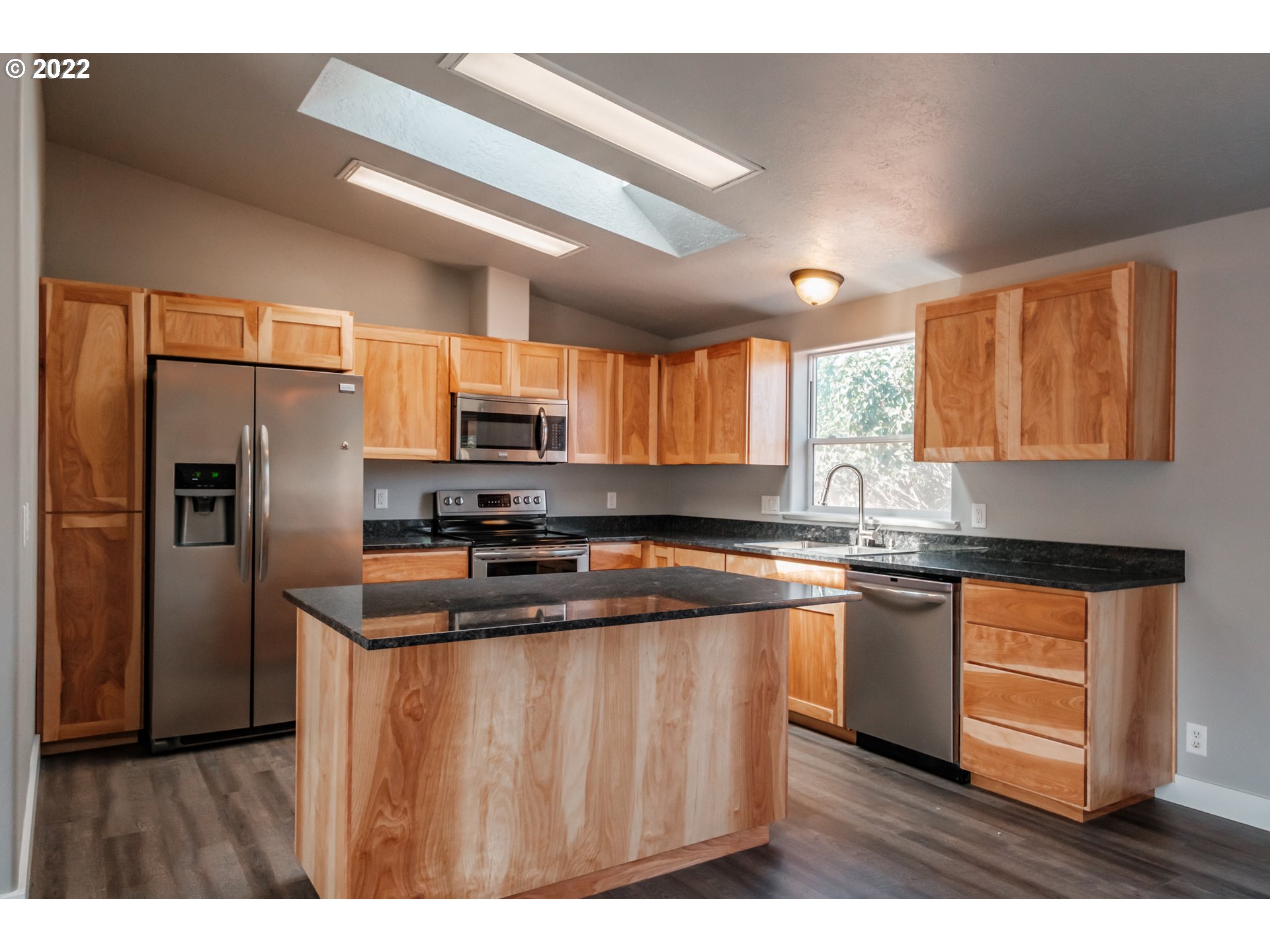 833 Northridge Avenue Springfield, OR 97477 - Photo 8 of 31 a kitchen with stainless steel appliances granite countertop a sink a stove a refrigerator with grey cabinets