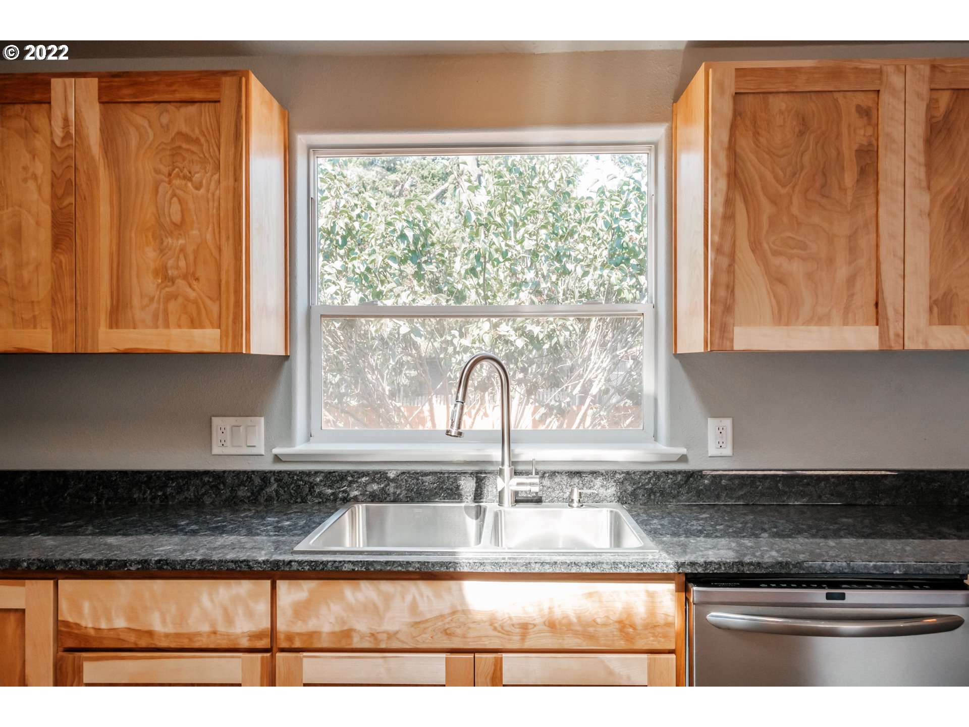 833 Northridge Avenue Springfield, OR 97477 - Photo 10 of 31 a kitchen with granite countertop a window a sink dishwasher and cabinets