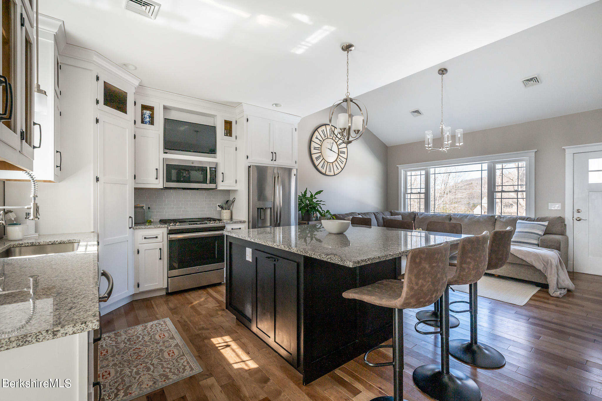 3 Chestnut Hill Road Monterey, MA 01245 - Photo 1 of 26 a kitchen with stainless steel appliances granite countertop a stove top oven a sink dishwasher a dining table and chairs with wooden floor