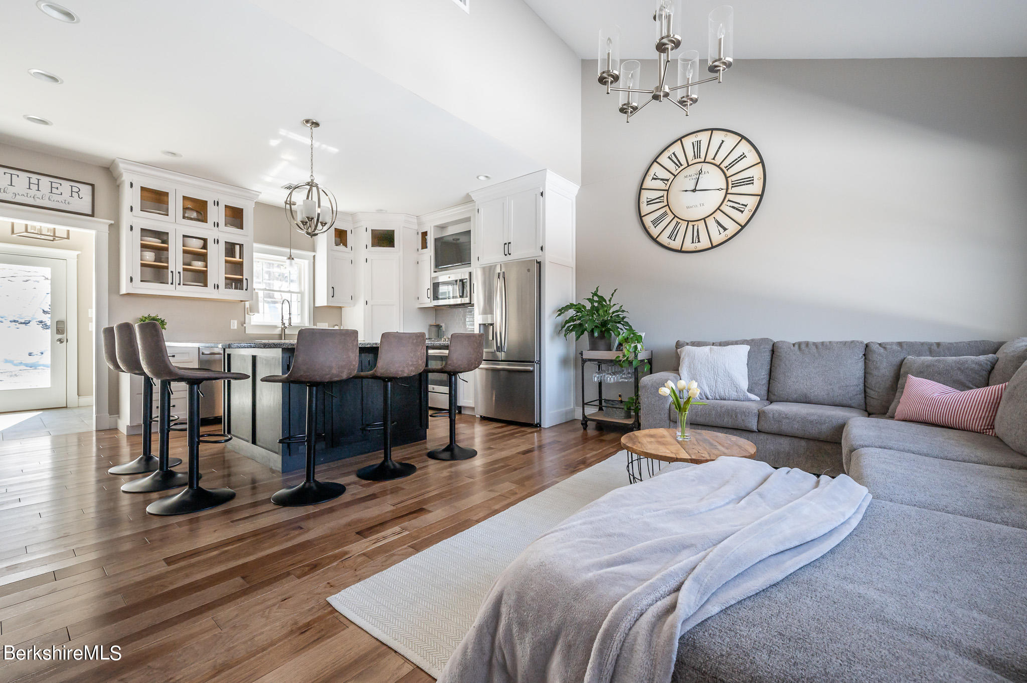 3 Chestnut Hill Road Monterey, MA 01245 - Photo 2 of 26 a living room with furniture a chandelier and a clock