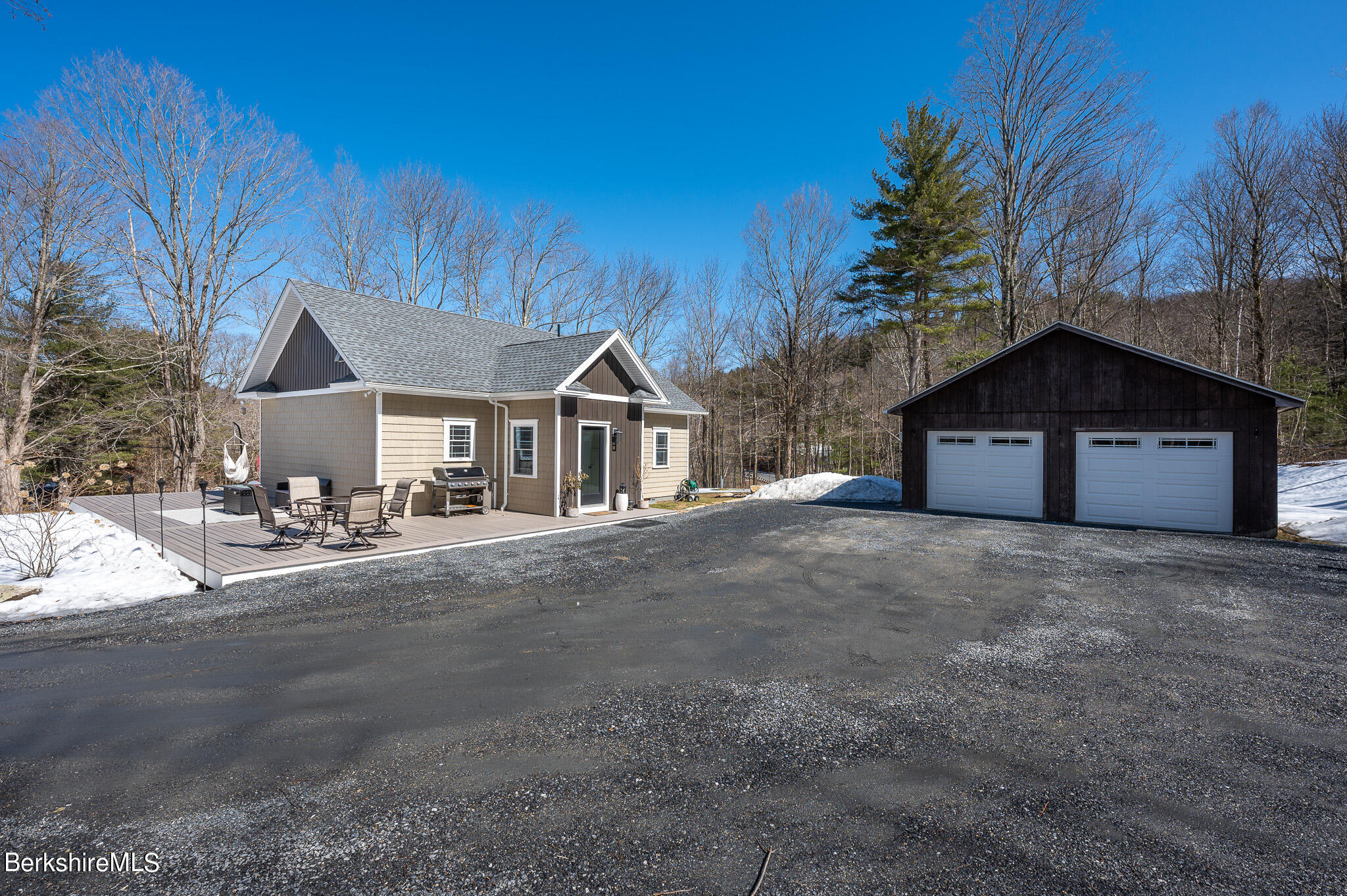 3 Chestnut Hill Road Monterey, MA 01245 - Photo 3 of 26 a front view of a house with a yard and garage