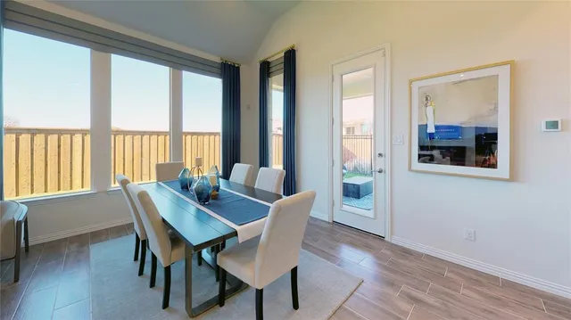 a dining room with furniture and window