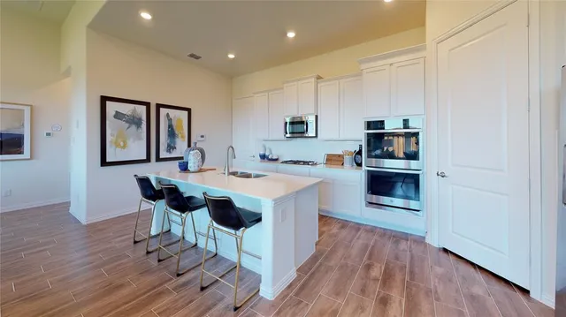 a view of kitchen with sink and wooden floor