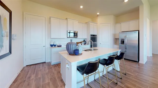 a view of kitchen with cabinets and wooden floor