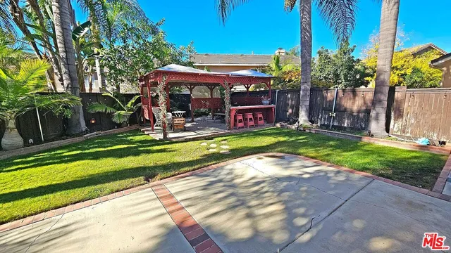 a view of a park with furniture and a yard