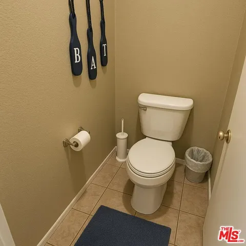 a white toilet sitting next to a white wall