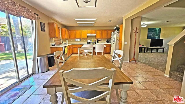 a view of a dining room with furniture large windows and wooden floor