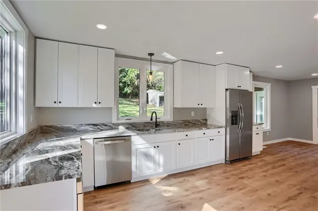 a kitchen with a sink stove and refrigerator