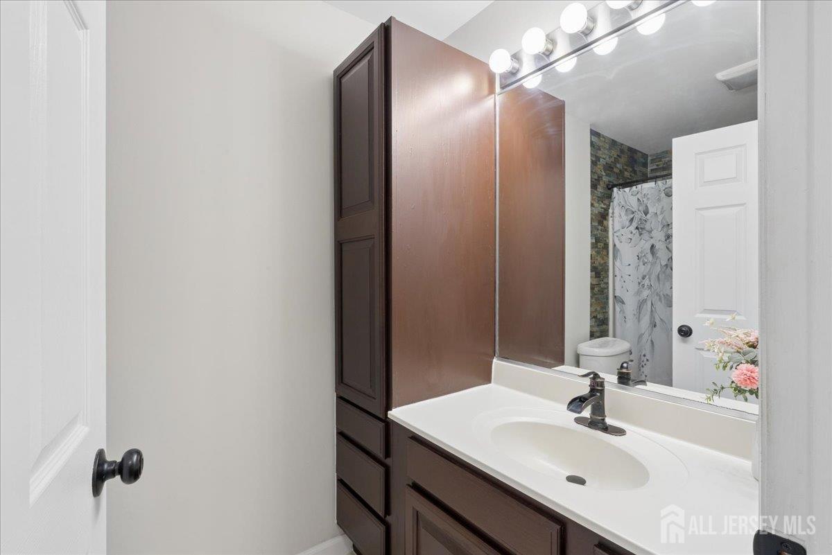 45 Walnut Street Edison, NJ 08817 - Photo 19 of 28 a bathroom with a sink and a mirror