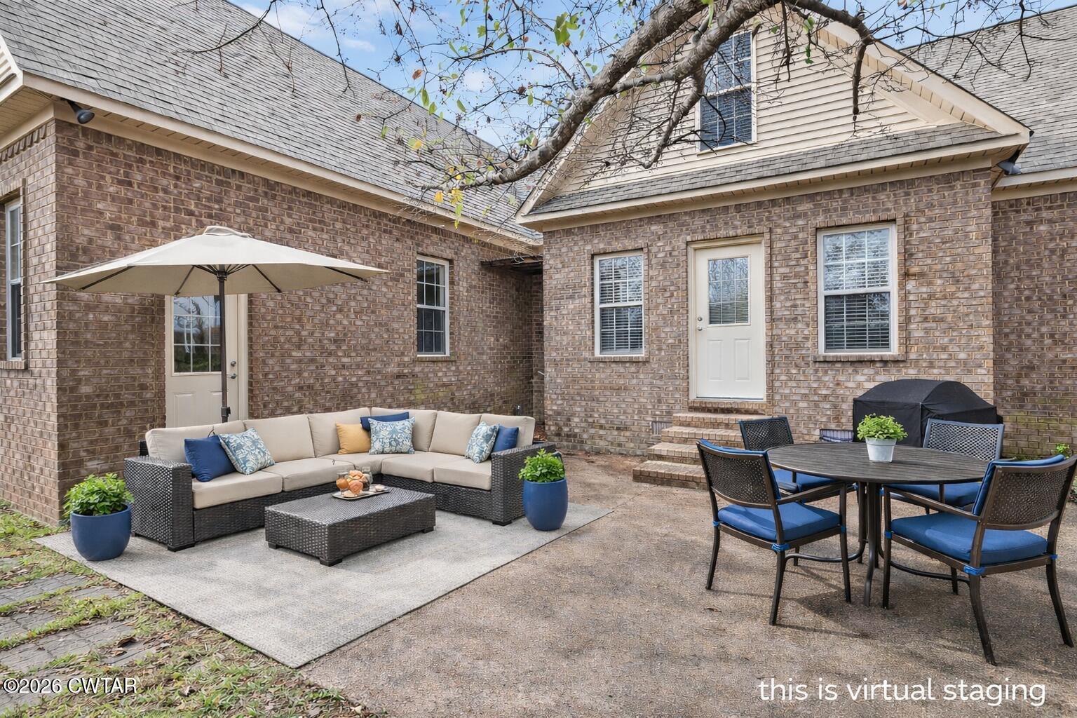 31 Turkey Creek Road Medina, TN 38355 - Photo 4 of 30 a view of a patio with couches table and chairs under an umbrella