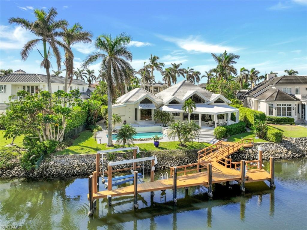 a front view of house with yard swimming pool and outdoor seating