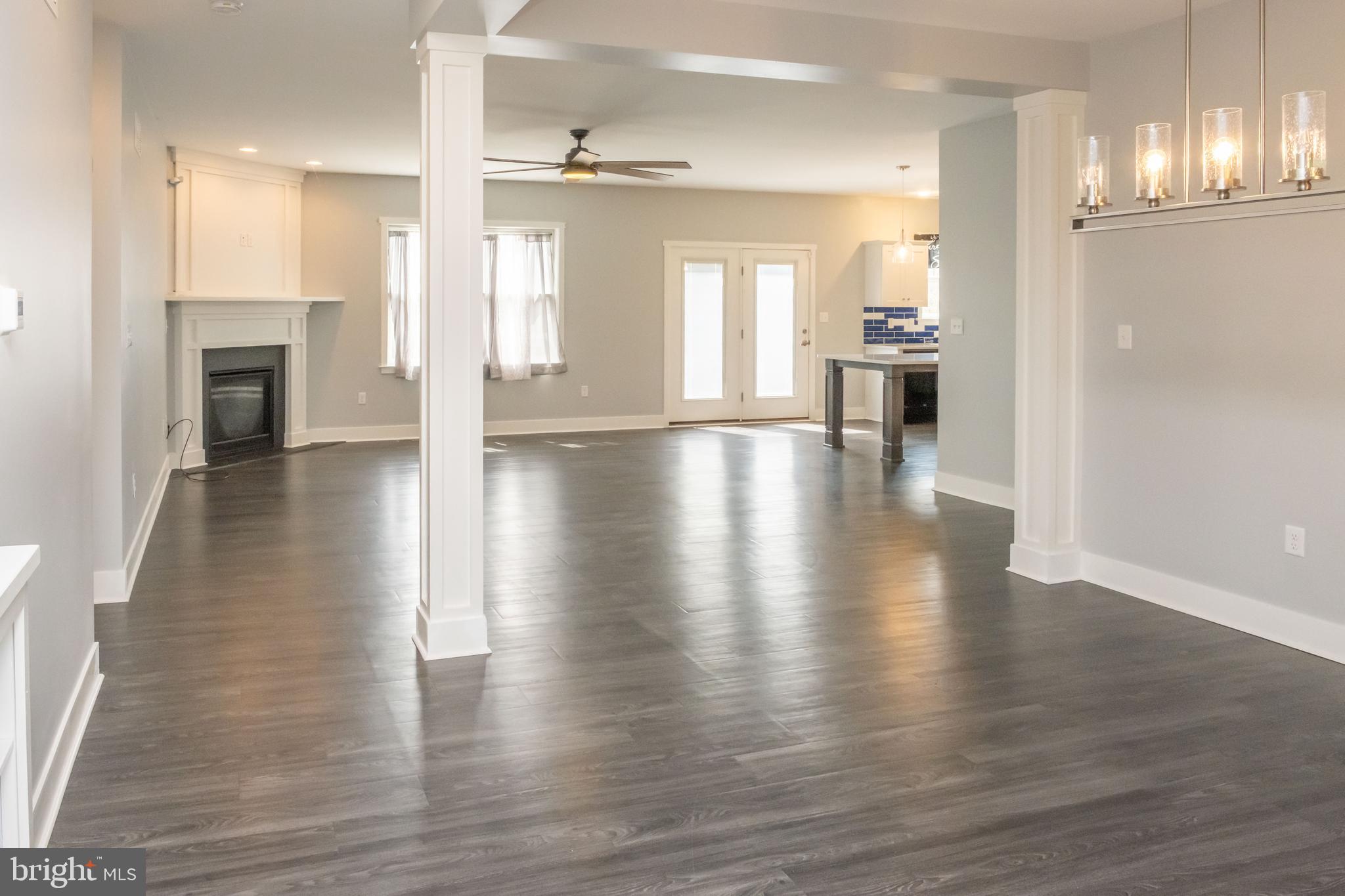 6042 Station Cir Road Harrisburg, PA 17111 - Photo 27 of 71 an empty room with wooden floor and a kitchen