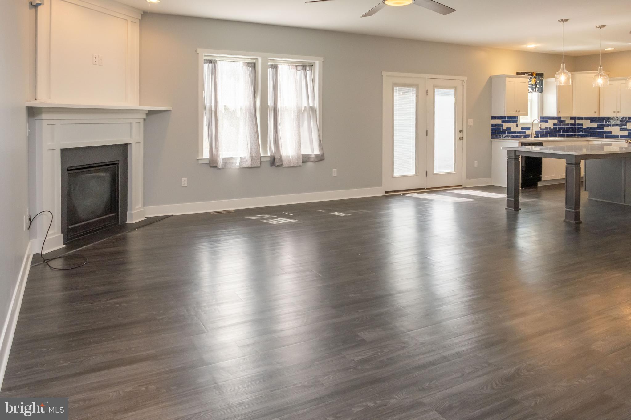 6042 Station Cir Road Harrisburg, PA 17111 - Photo 29 of 71 an empty room with wooden floor fireplace and windows
