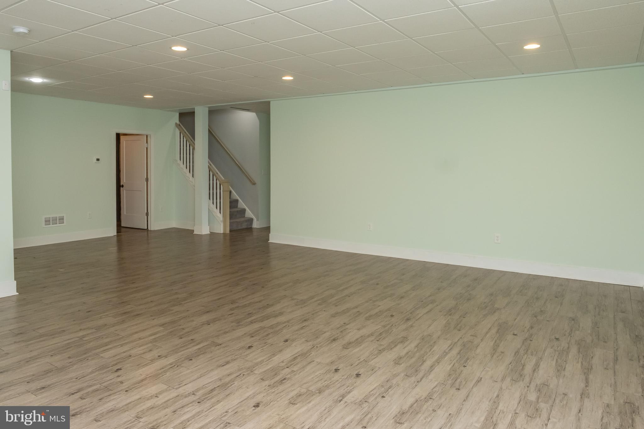 6042 Station Cir Road Harrisburg, PA 17111 - Photo 59 of 71 an empty room with wooden floor and a hallway