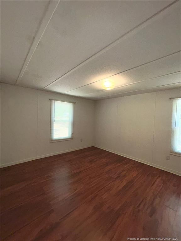 110 Kinton Drive Willow Spring, NC 27592 - Photo 14 of 50 an empty room with wooden floor and windows