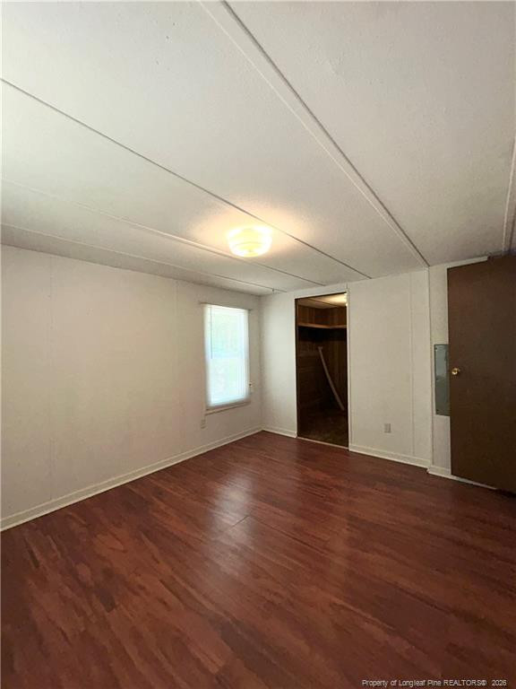110 Kinton Drive Willow Spring, NC 27592 - Photo 15 of 50 an empty room with wooden floor and windows