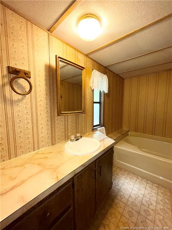 110 Kinton Drive Willow Spring, NC 27592 - Photo 21 of 50 a bathroom with a granite countertop sink and a mirror