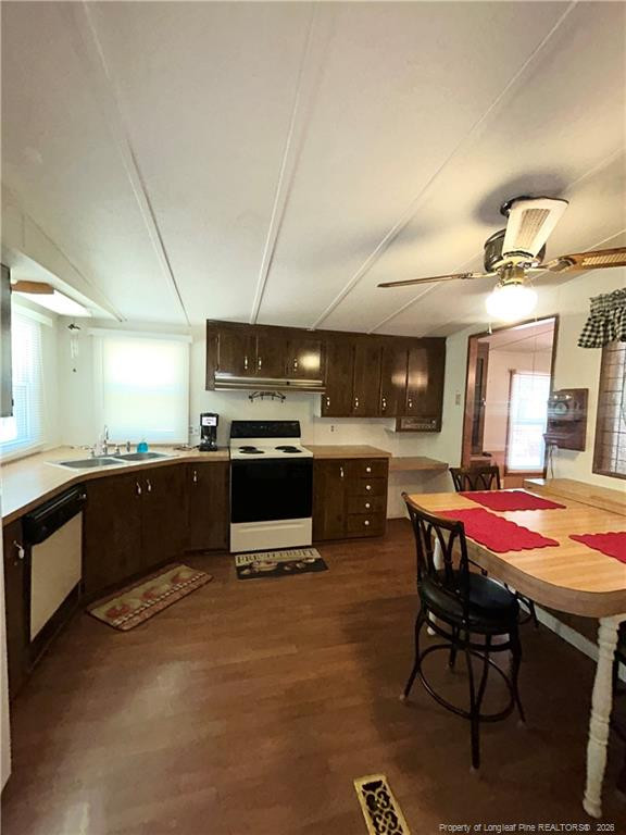 110 Kinton Drive Willow Spring, NC 27592 - Photo 30 of 50 a kitchen with stainless steel appliances kitchen island granite countertop a table chairs sink and cabinets