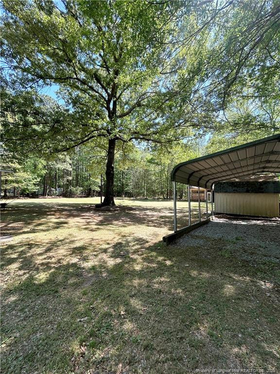 110 Kinton Drive Willow Spring, NC 27592 - Photo 38 of 50 a view of a bench with wooden fence